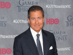 HBO's CEO Richard Plepler stands front of a promo for a Game of Thrones season premiere